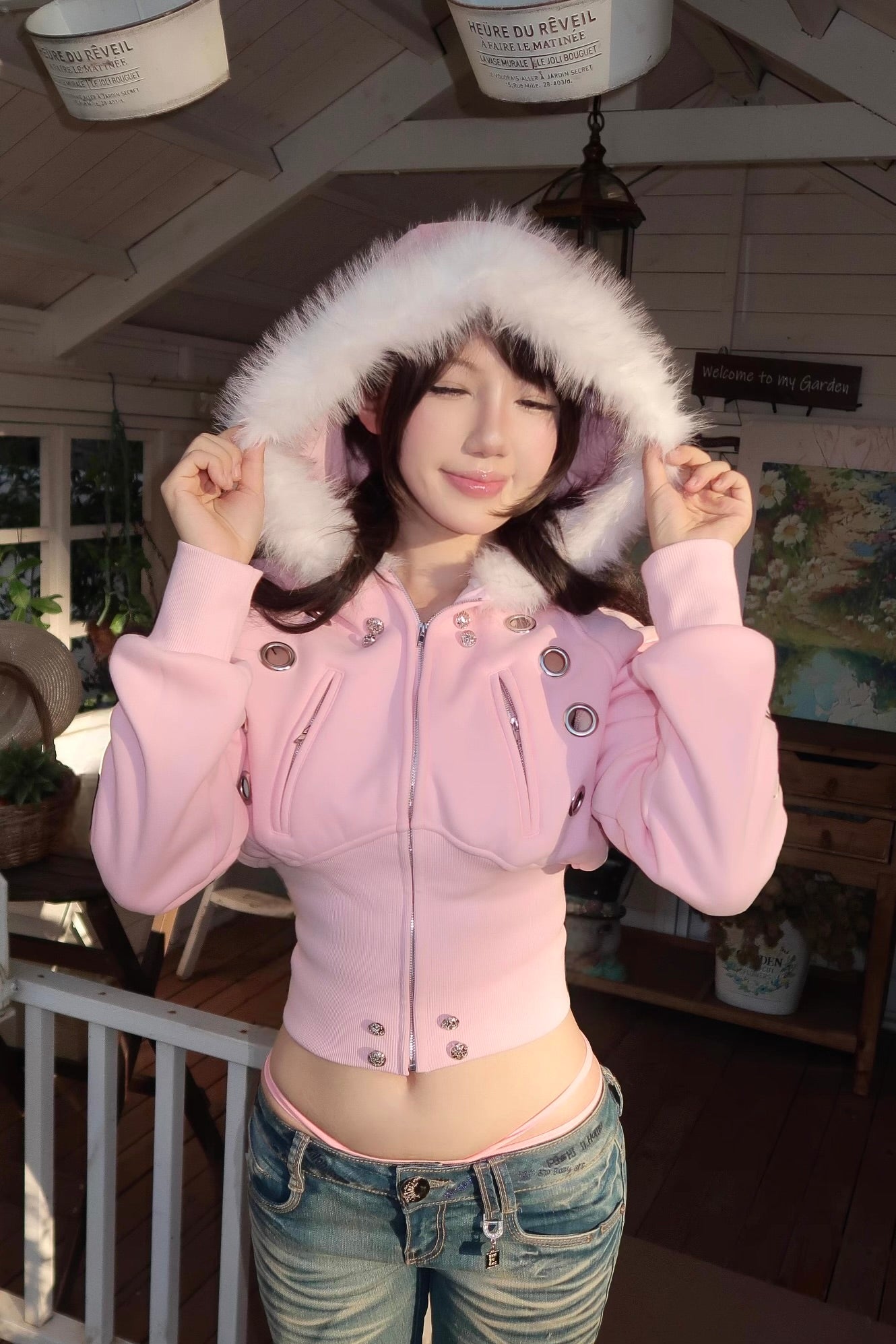 furry hooded sweatshirt and a black embroidered jacket