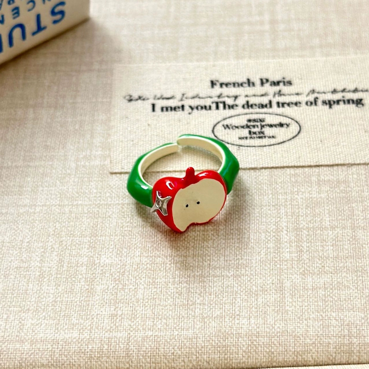 A necklace with apple earrings and ear clips