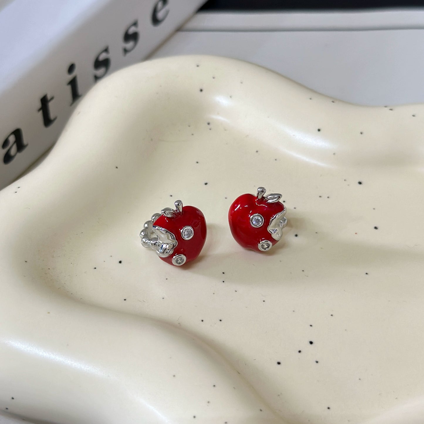 A necklace with apple earrings and ear clips