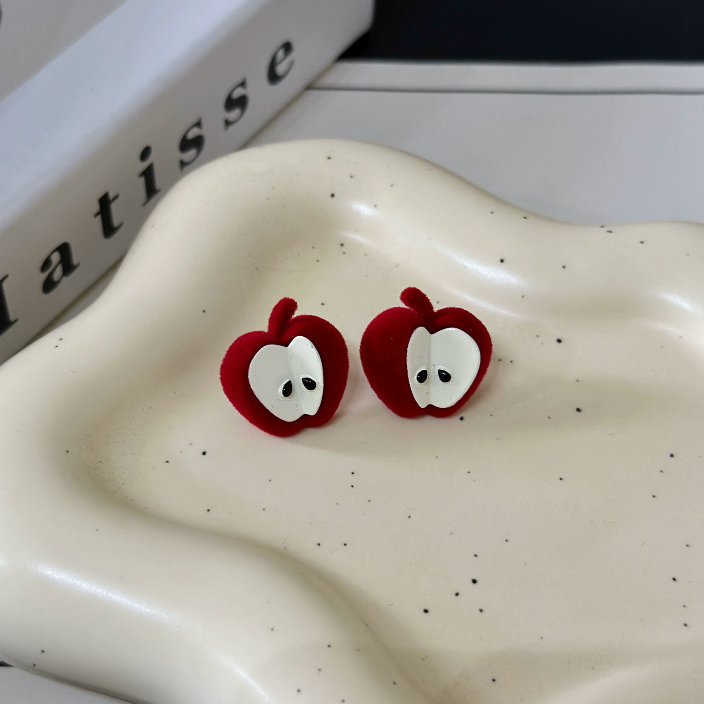 A necklace with apple earrings and ear clips