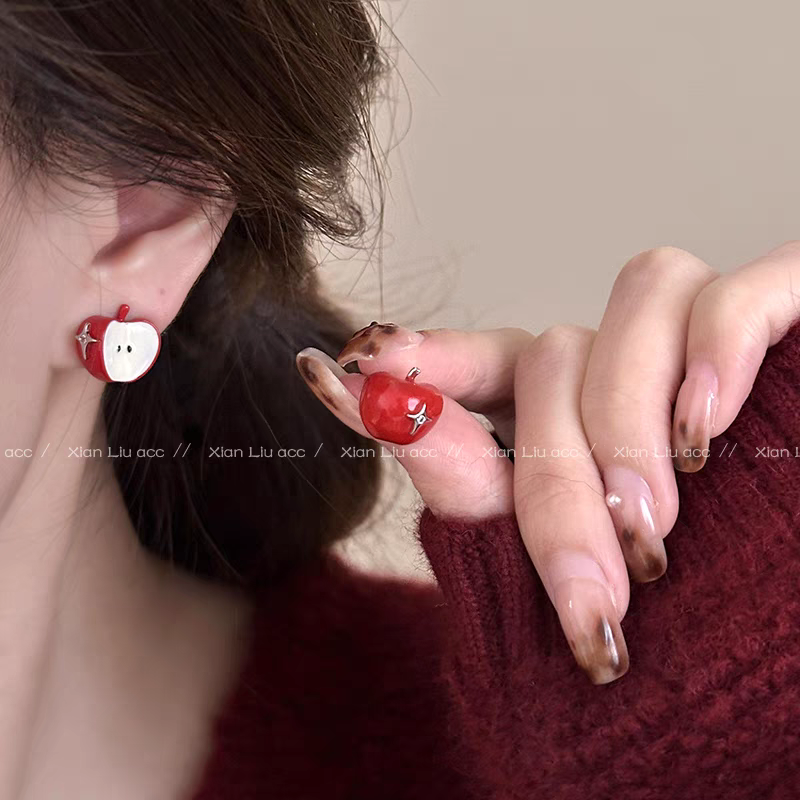 A necklace with apple earrings and ear clips