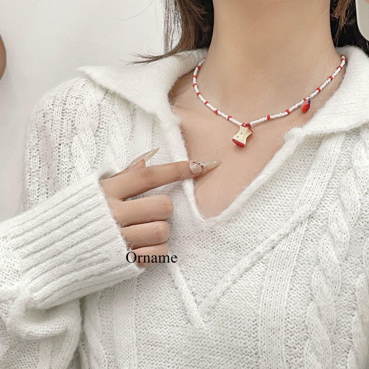 A necklace with apple earrings and ear clips