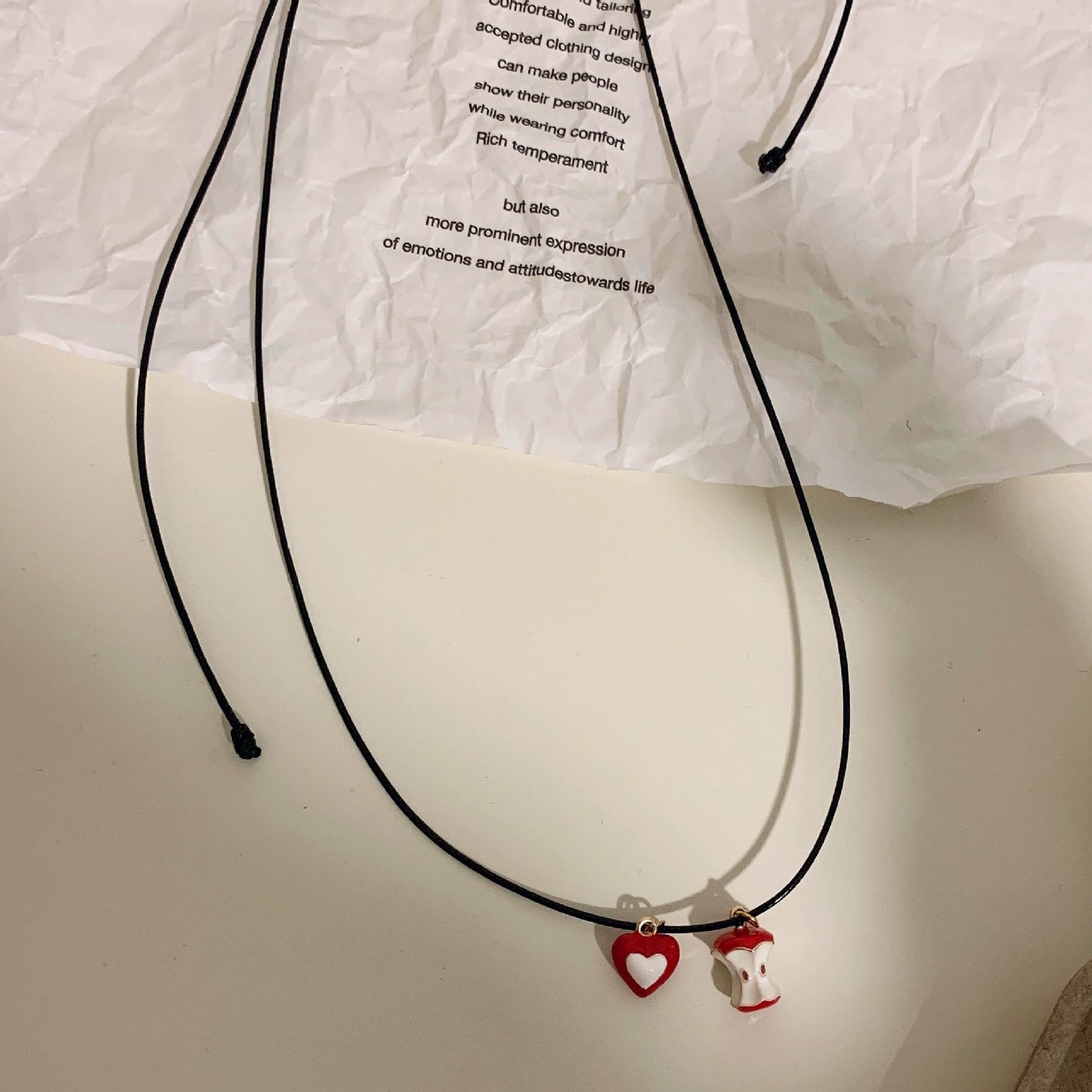 A necklace with apple earrings and ear clips
