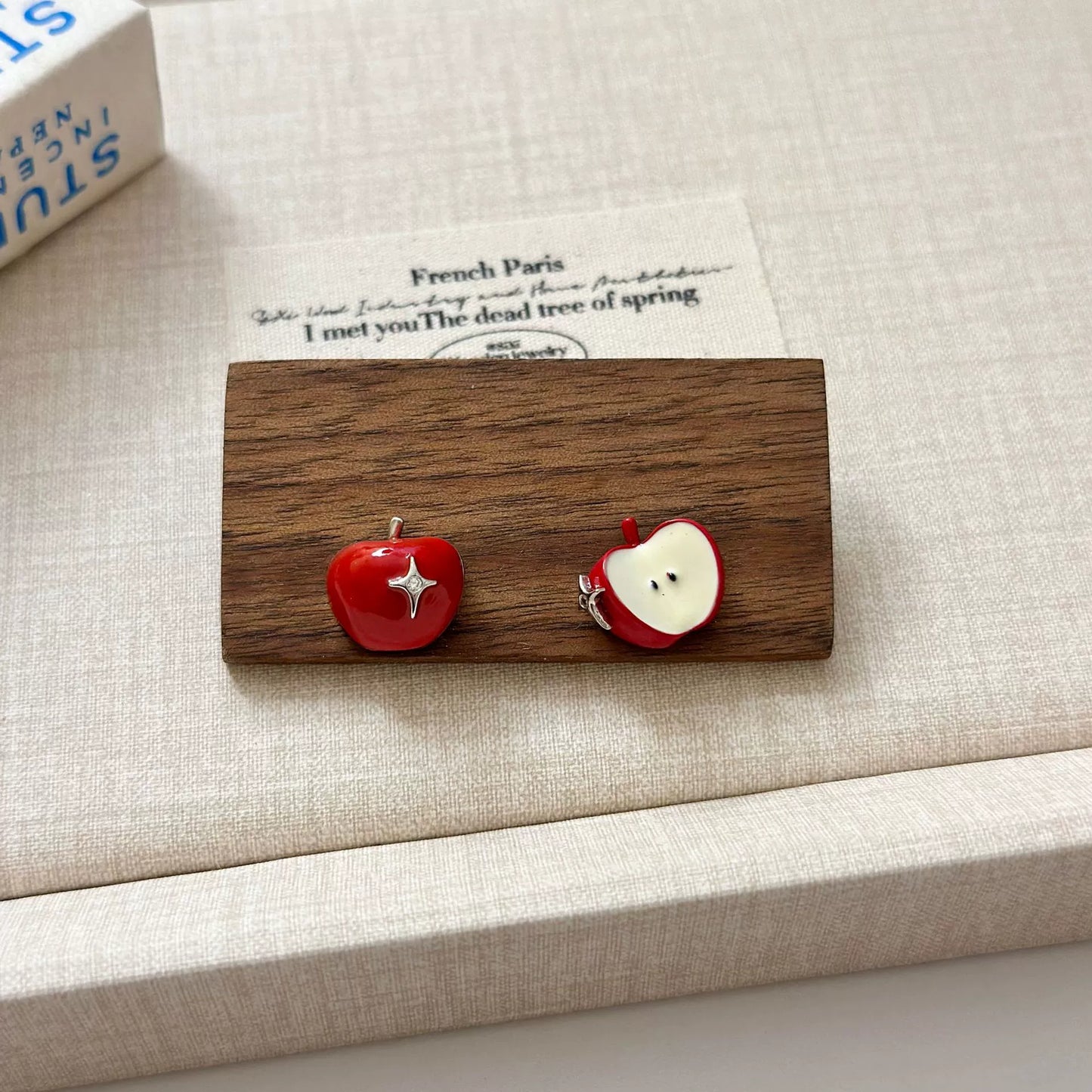 A necklace with apple earrings and ear clips