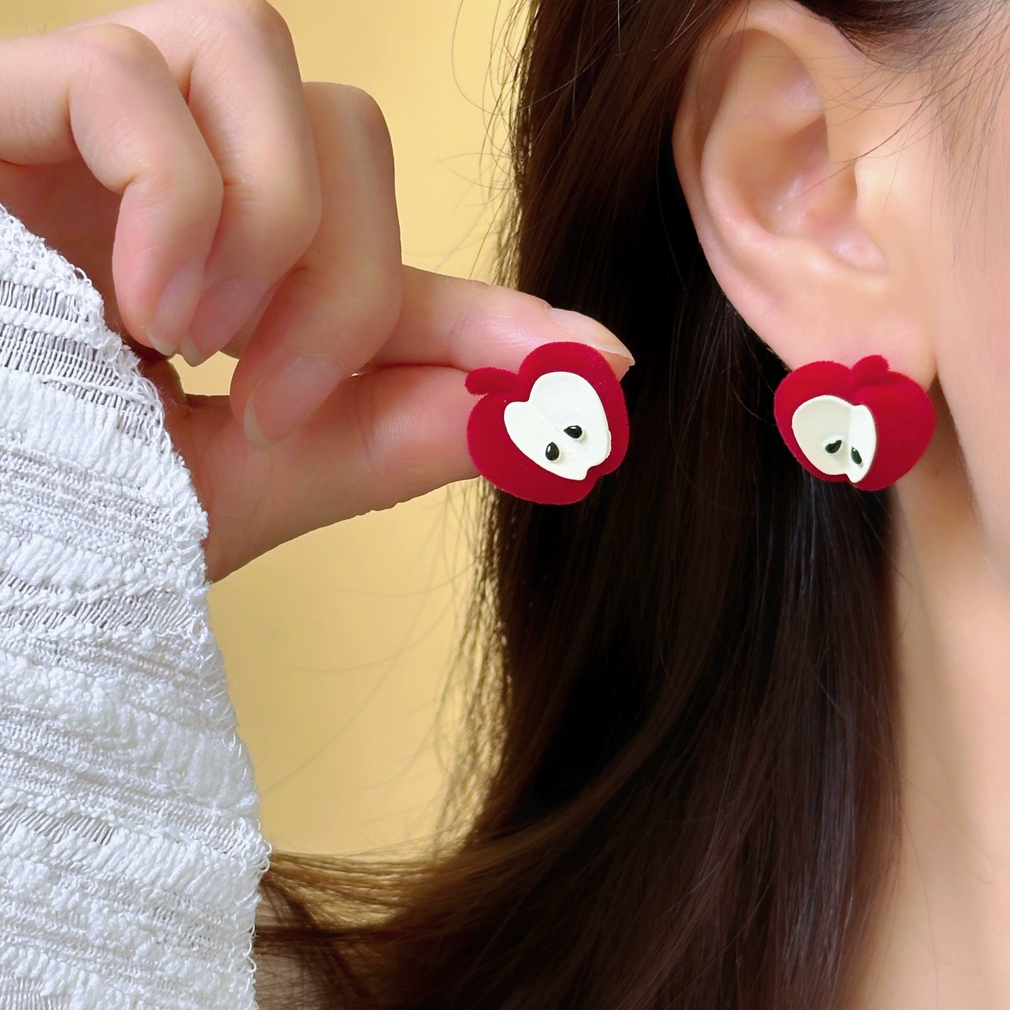 A necklace with apple earrings and ear clips