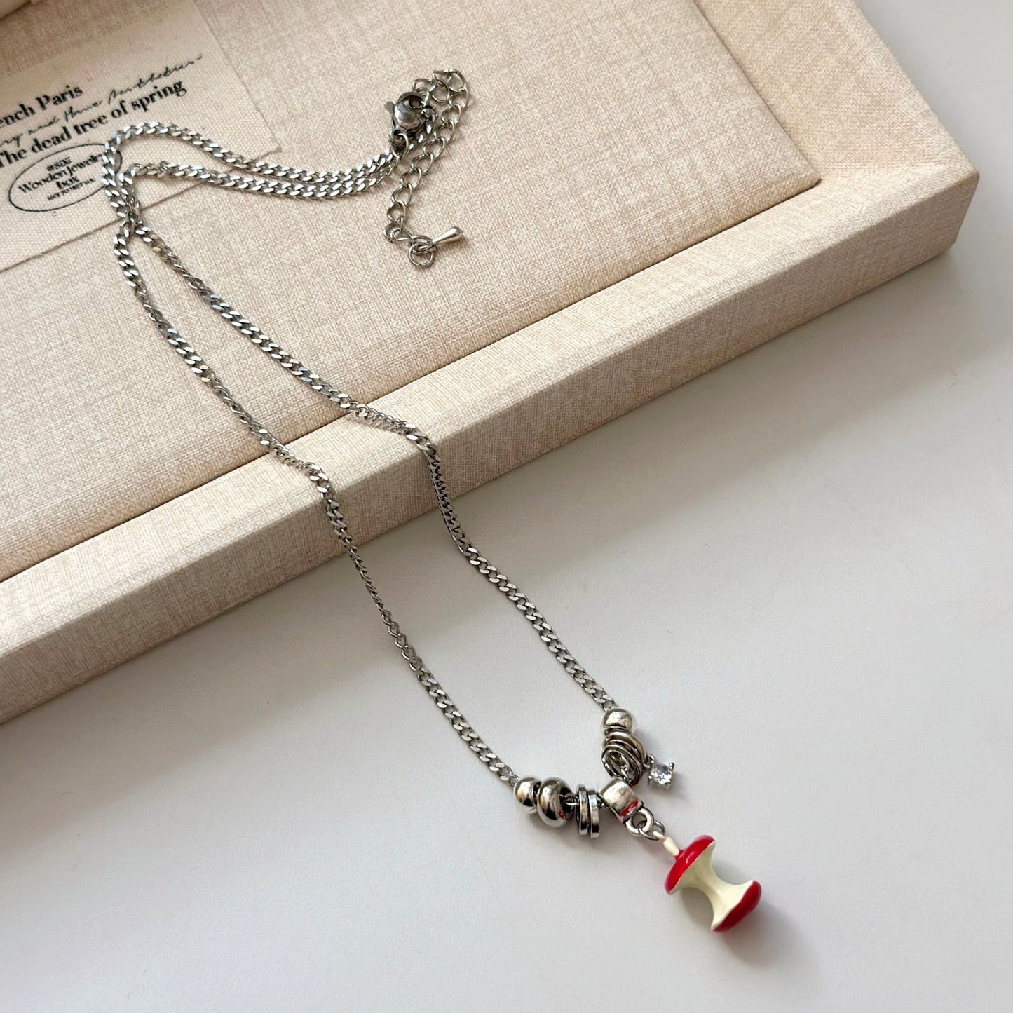 A necklace with apple earrings and ear clips