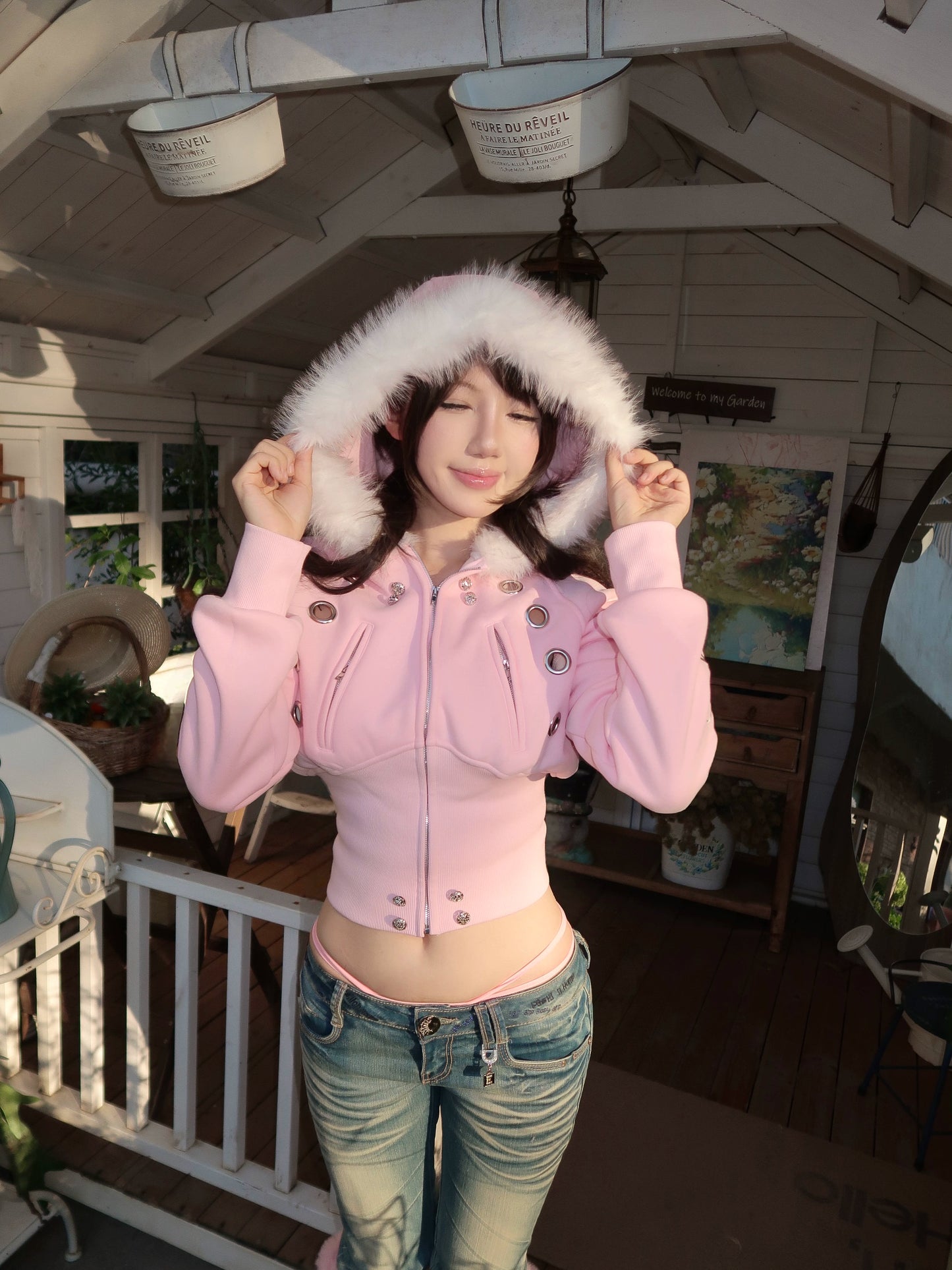 furry hooded sweatshirt and a black embroidered jacket