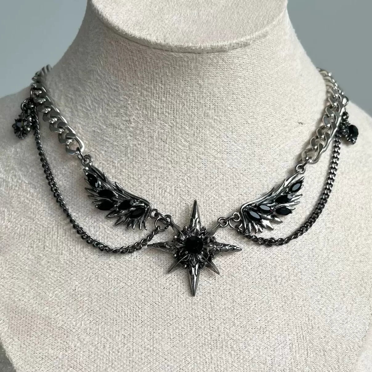 Black winged starry necklace earrings