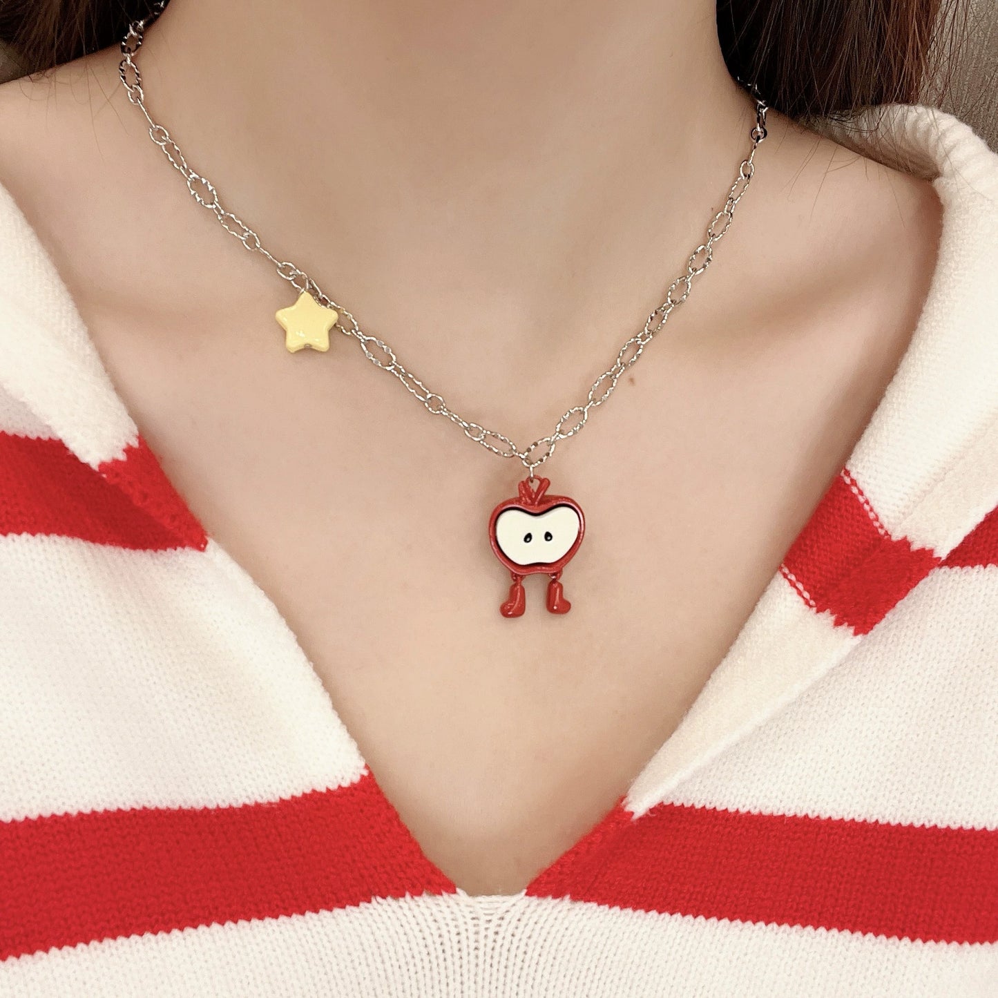 A necklace with apple earrings and ear clips