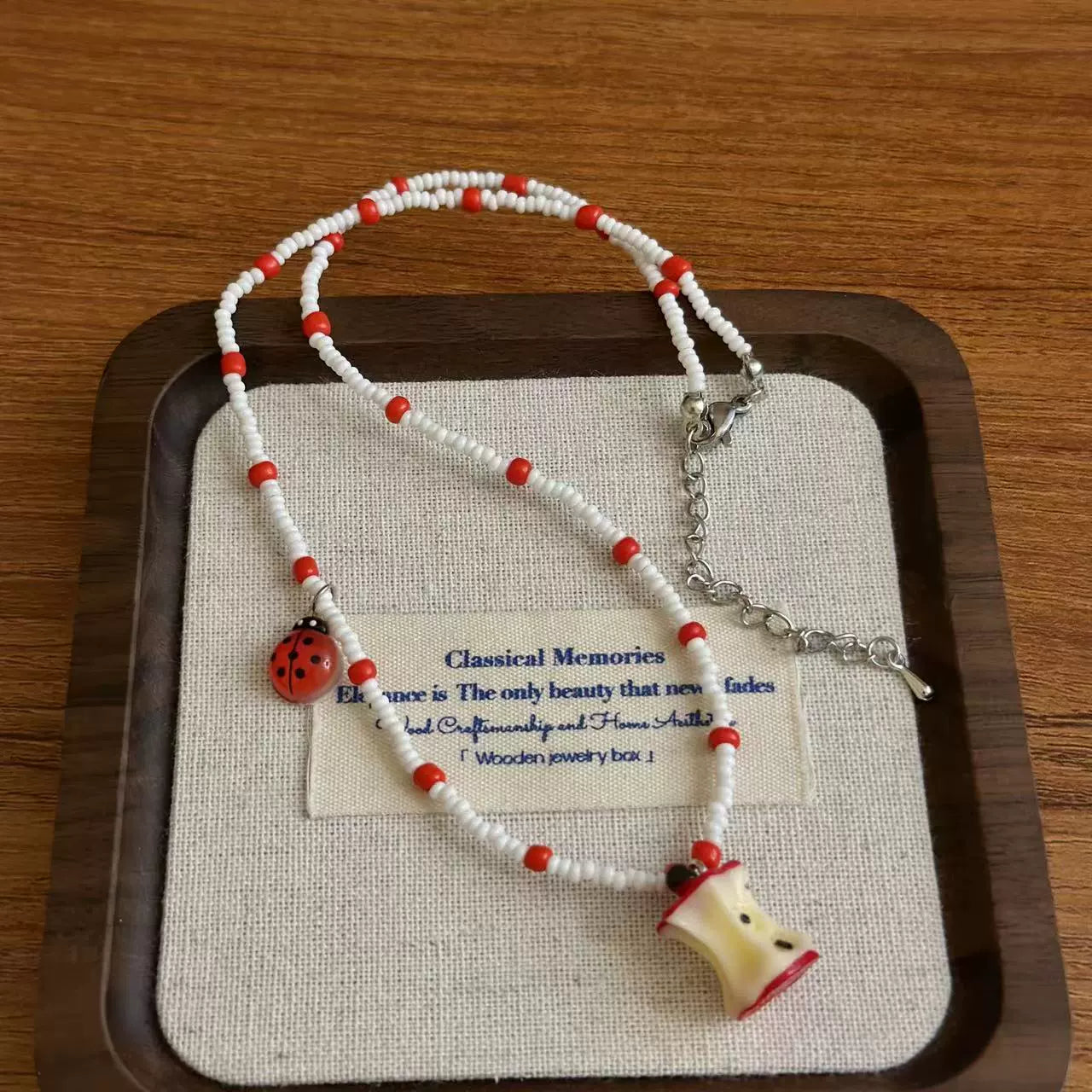 A necklace with apple earrings and ear clips